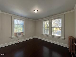 200 East Edenton Street, Unit 4 Raleigh, NC 27601 - Photo 12 of 17 a view of an empty room with wooden floor and a window