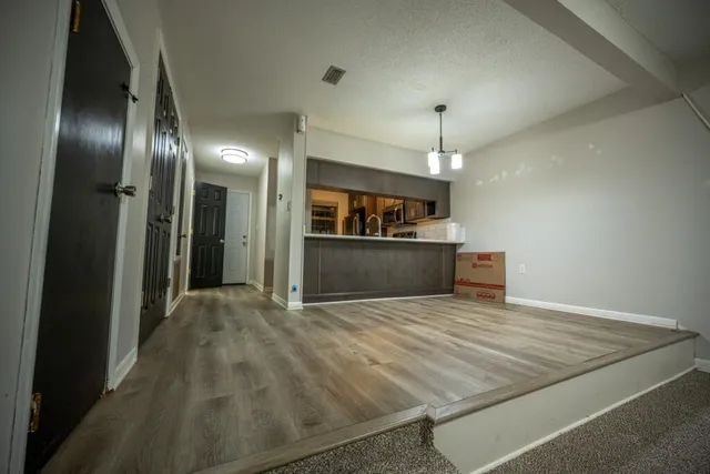 a view of a kitchen with a sink and a refrigerator