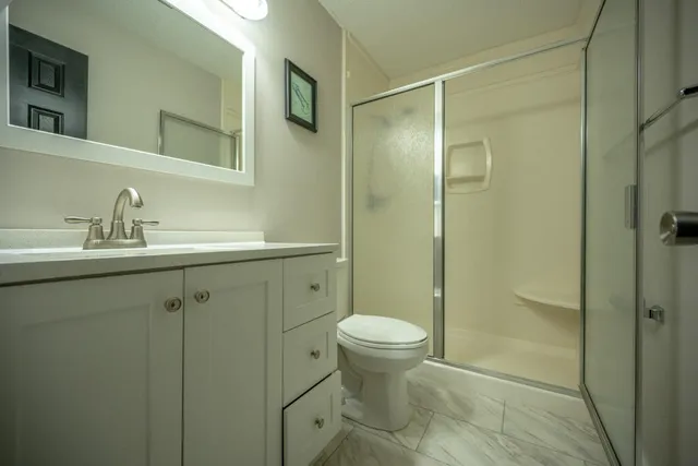 a bathroom with a sink toilet and shower