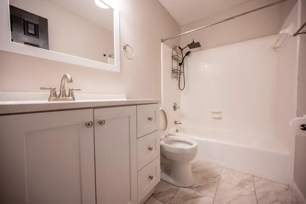 a bathroom with a sink toilet and shower