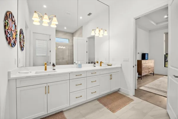 a spacious bathroom with a double vanity sink mirror and