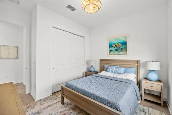 a bedroom with a bed and a painting on the wall