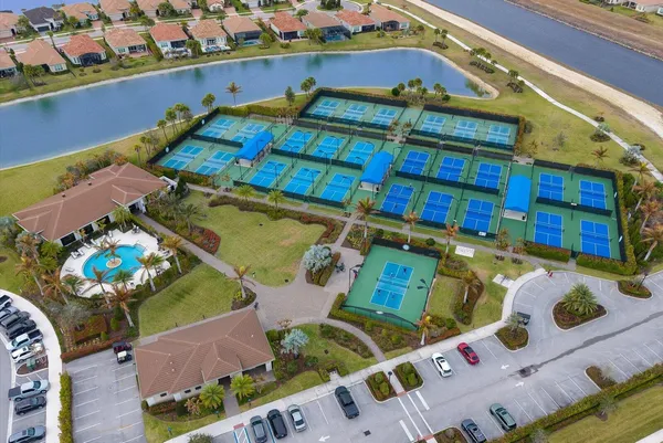 an aerial view of a house with a swimming pool outdoor seating
