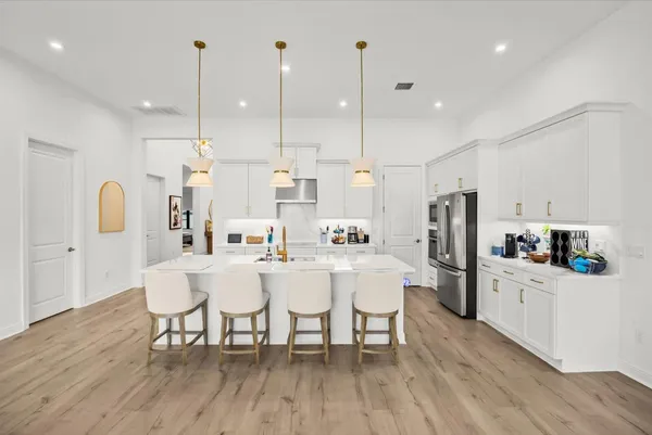 a large kitchen with a table and chairs