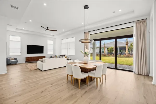 a living room with furniture a flat screen tv and a large window