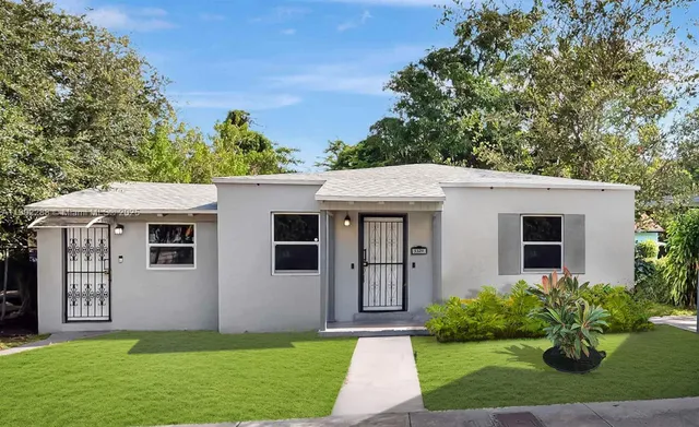 a front view of house with yard and green space