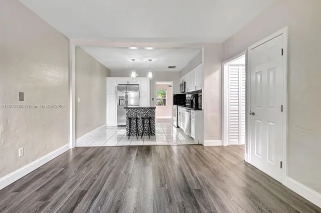a view of a kitchen with dining space and wooden floor