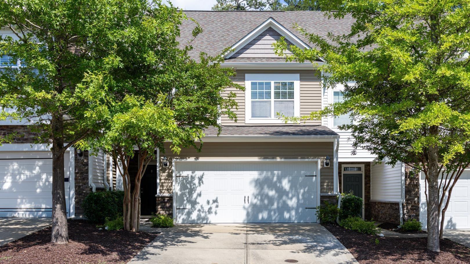 228 Skyros Loop Cary, NC 27519 - Photo 1 of 29 a front view of a house with garden
