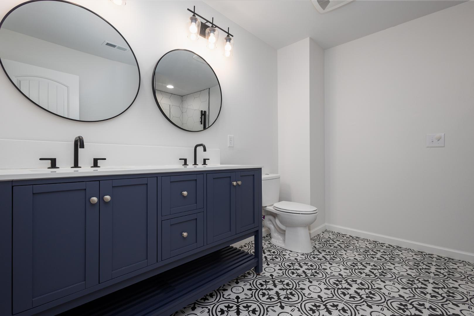 228 Skyros Loop Cary, NC 27519 - Photo 12 of 29 a bathroom with a toilet a sink and a mirror