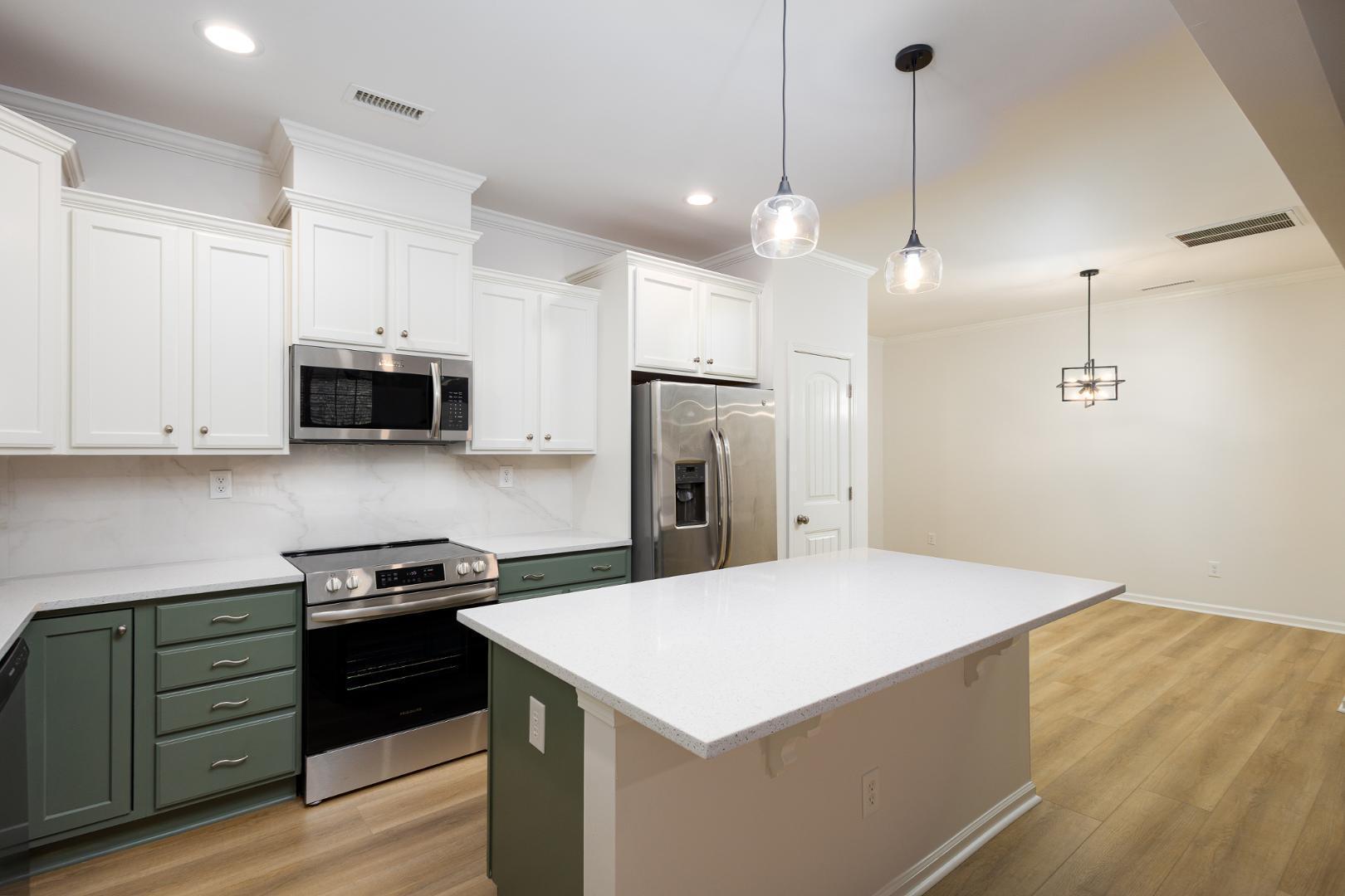228 Skyros Loop Cary, NC 27519 - Photo 23 of 29 a kitchen with a stove a sink and a refrigerator
