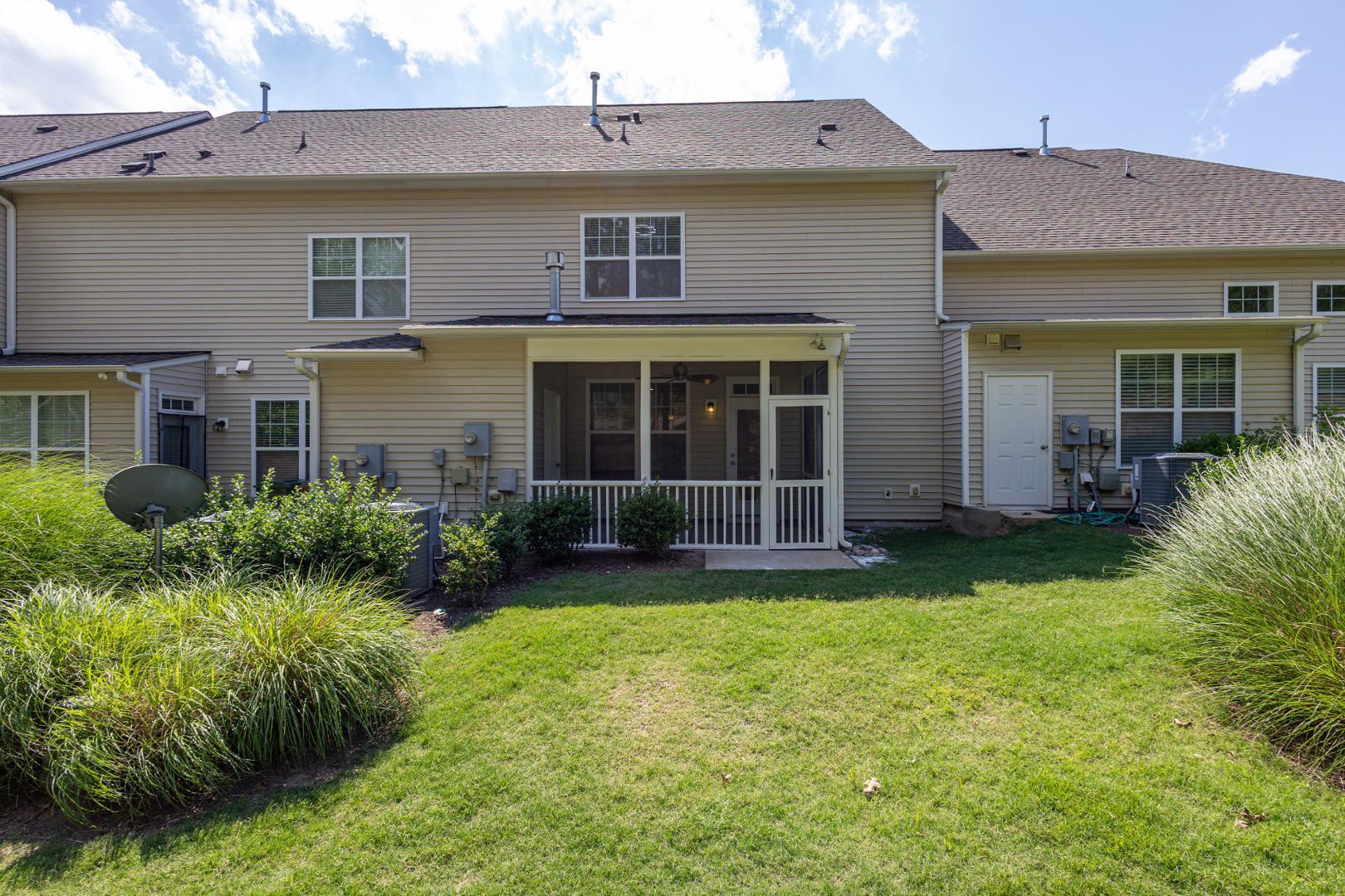 228 Skyros Loop Cary, NC 27519 - Photo 9 of 29 a view of a brick house with a yard and plants