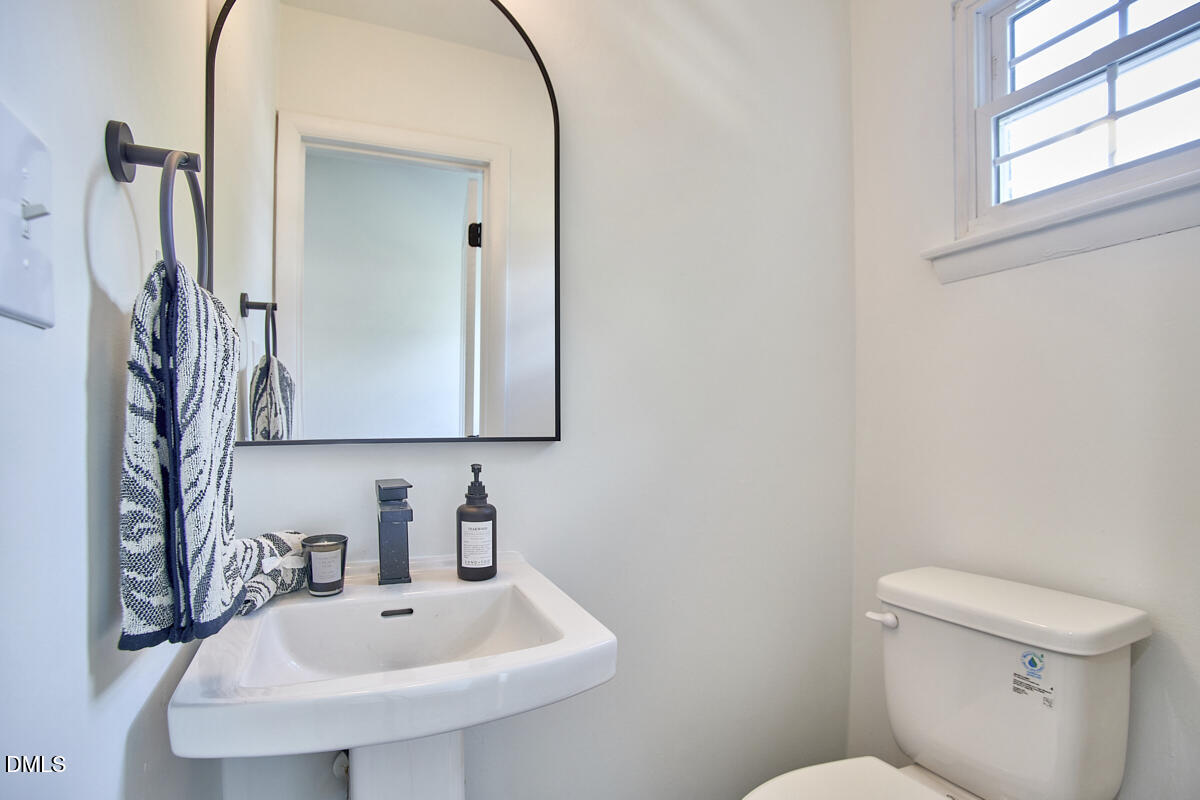 2613 McNeil Street, Unit E Raleigh, NC 27608 - Photo 15 of 28 a bathroom with a sink a toilet and mirror