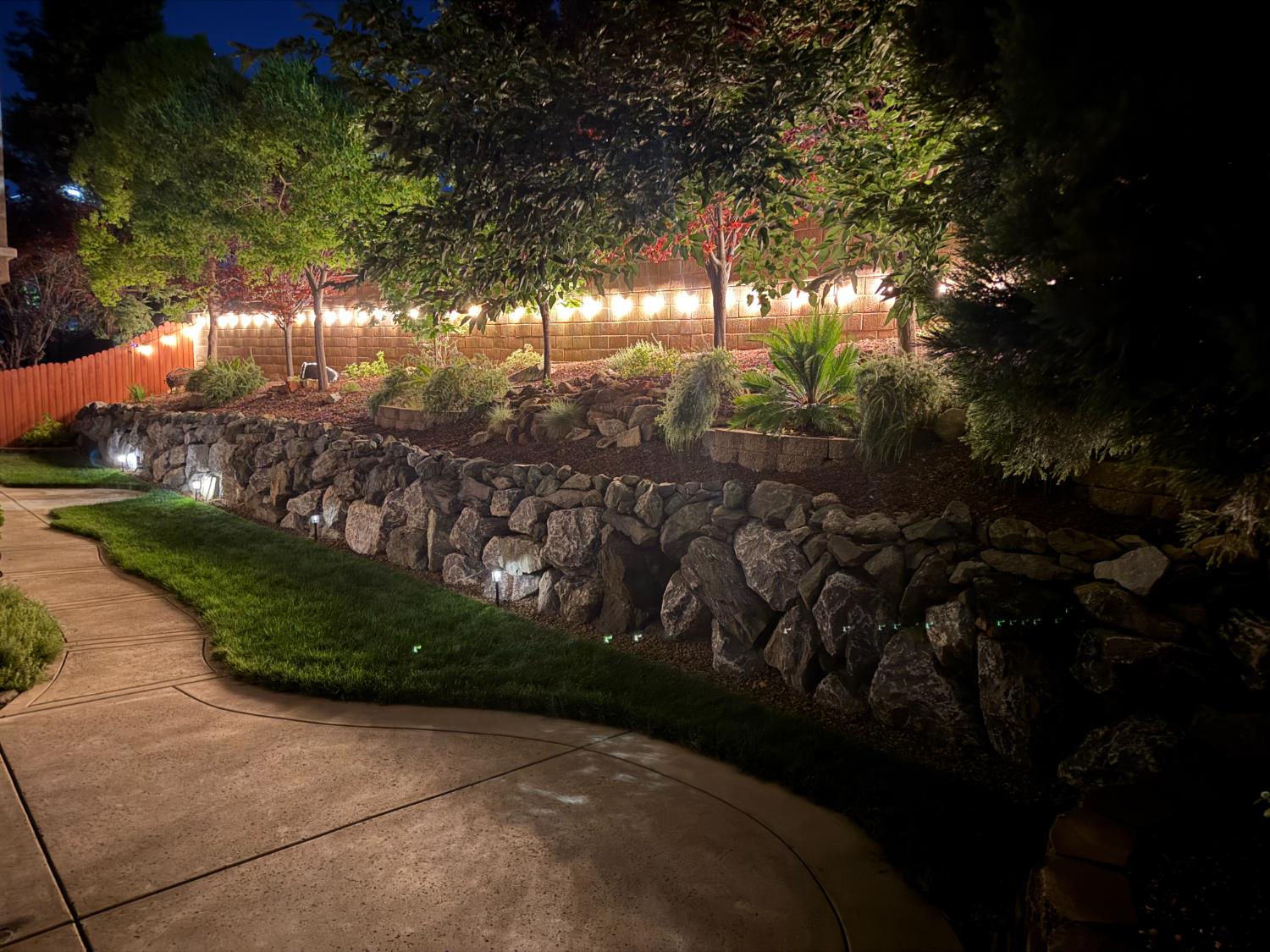 5950 Tanus Circle Rocklin, CA 95677 - Photo 60 of 70 Photo from 2025 showing evening landscape lighting.