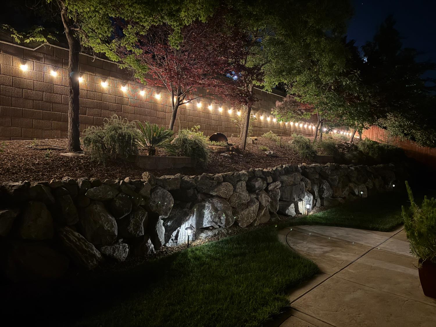 5950 Tanus Circle Rocklin, CA 95677 - Photo 61 of 70 Photo from 2025 showing evening landscape lighting.