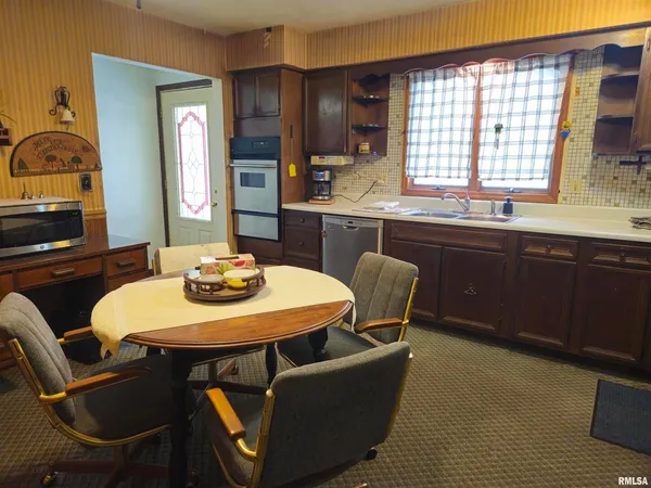 a dining room with furniture and window