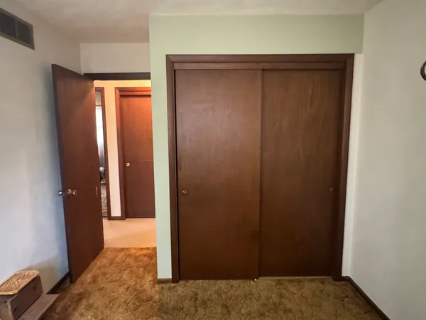 an empty room with closet area