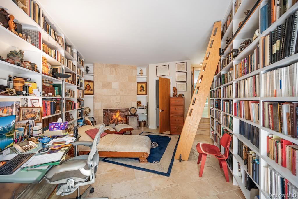 2222 Noyack Road Sag Harbor, NY 11963 - Photo 19 of 47 a view of living room with furniture and book shelf