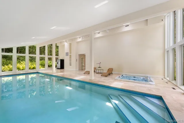 a bathroom with a granite countertop sink and a large mirror