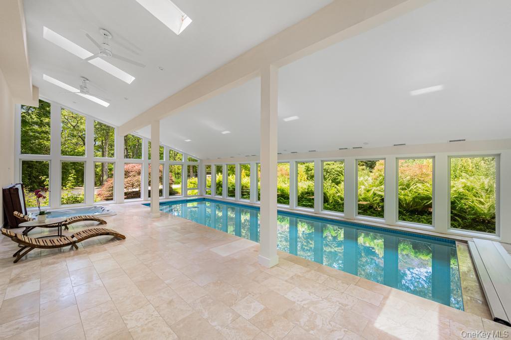 2222 Noyack Road Sag Harbor, NY 11963 - Photo 22 of 47 a view of a room with furniture and floor to ceiling window