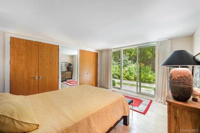 a bedroom with a bed and glass window