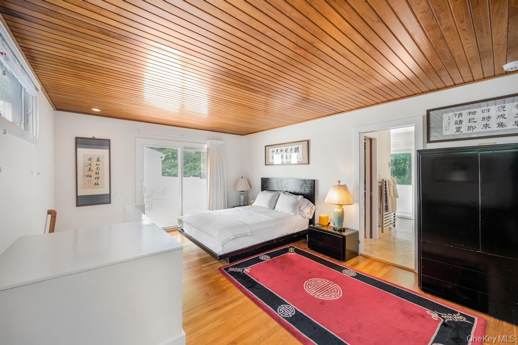 2222 Noyack Road Sag Harbor, NY 11963 - Photo 32 of 47 a bedroom with furniture and a window