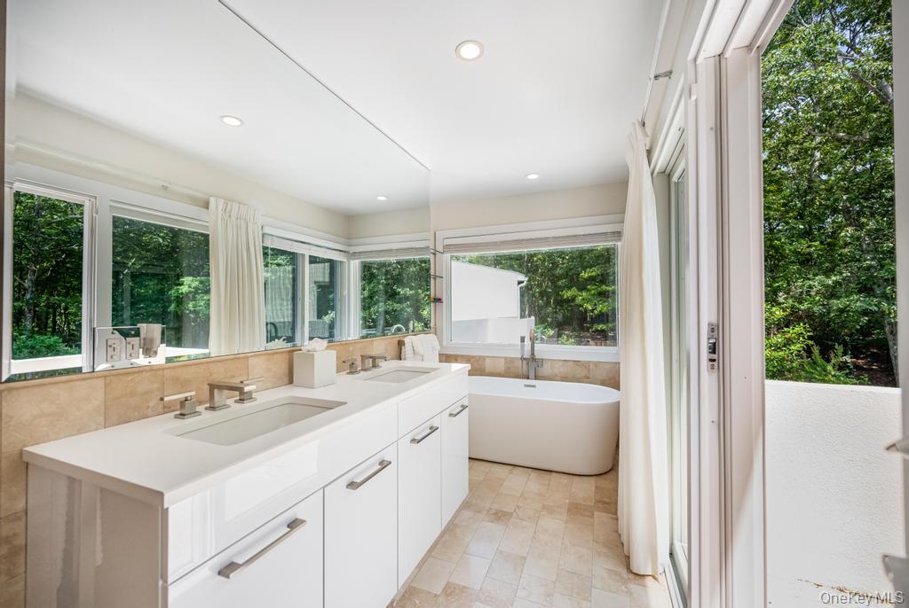 2222 Noyack Road Sag Harbor, NY 11963 - Photo 33 of 47 a view of a bathroom with a sink and a bathtub