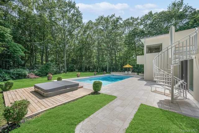 a view of a house with a yard and sitting area