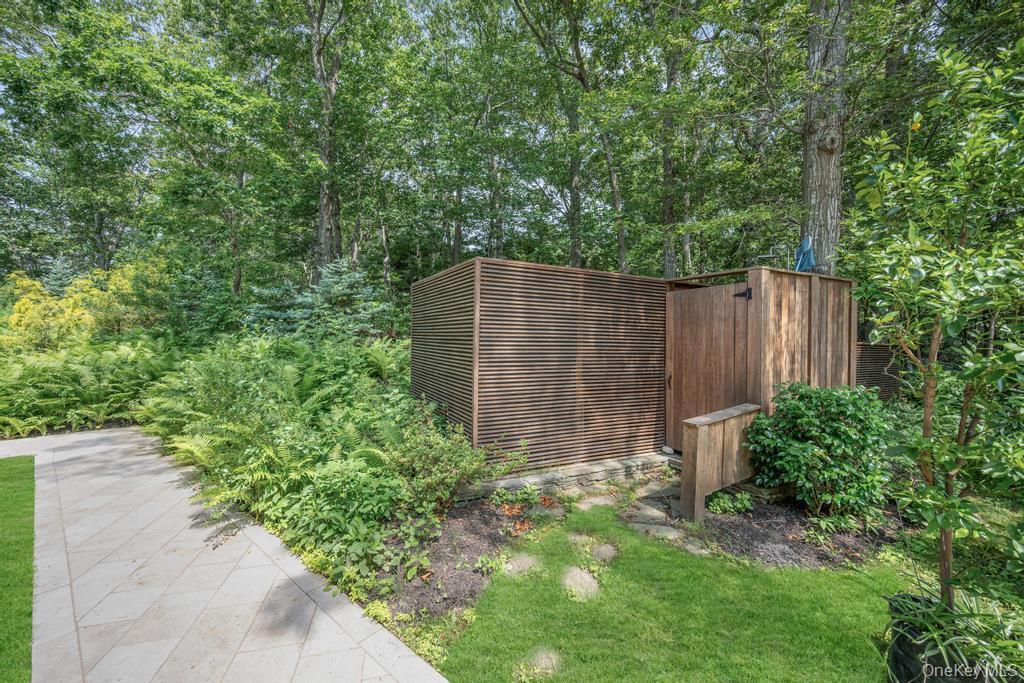 2222 Noyack Road Sag Harbor, NY 11963 - Photo 40 of 47 a backyard of a house with lots of green space