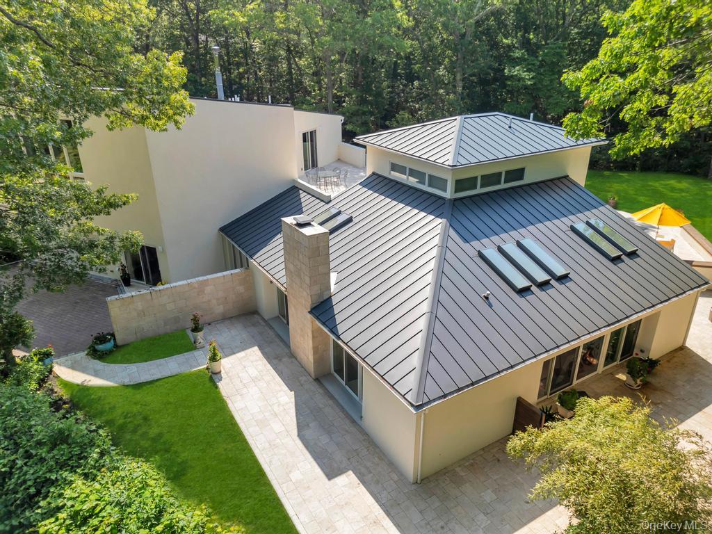 2222 Noyack Road Sag Harbor, NY 11963 - Photo 6 of 47 a view of a patio with table and chairs potted plants and large tree