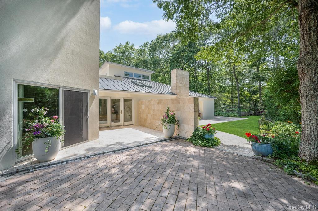 2222 Noyack Road Sag Harbor, NY 11963 - Photo 7 of 47 a front view of a house with garden