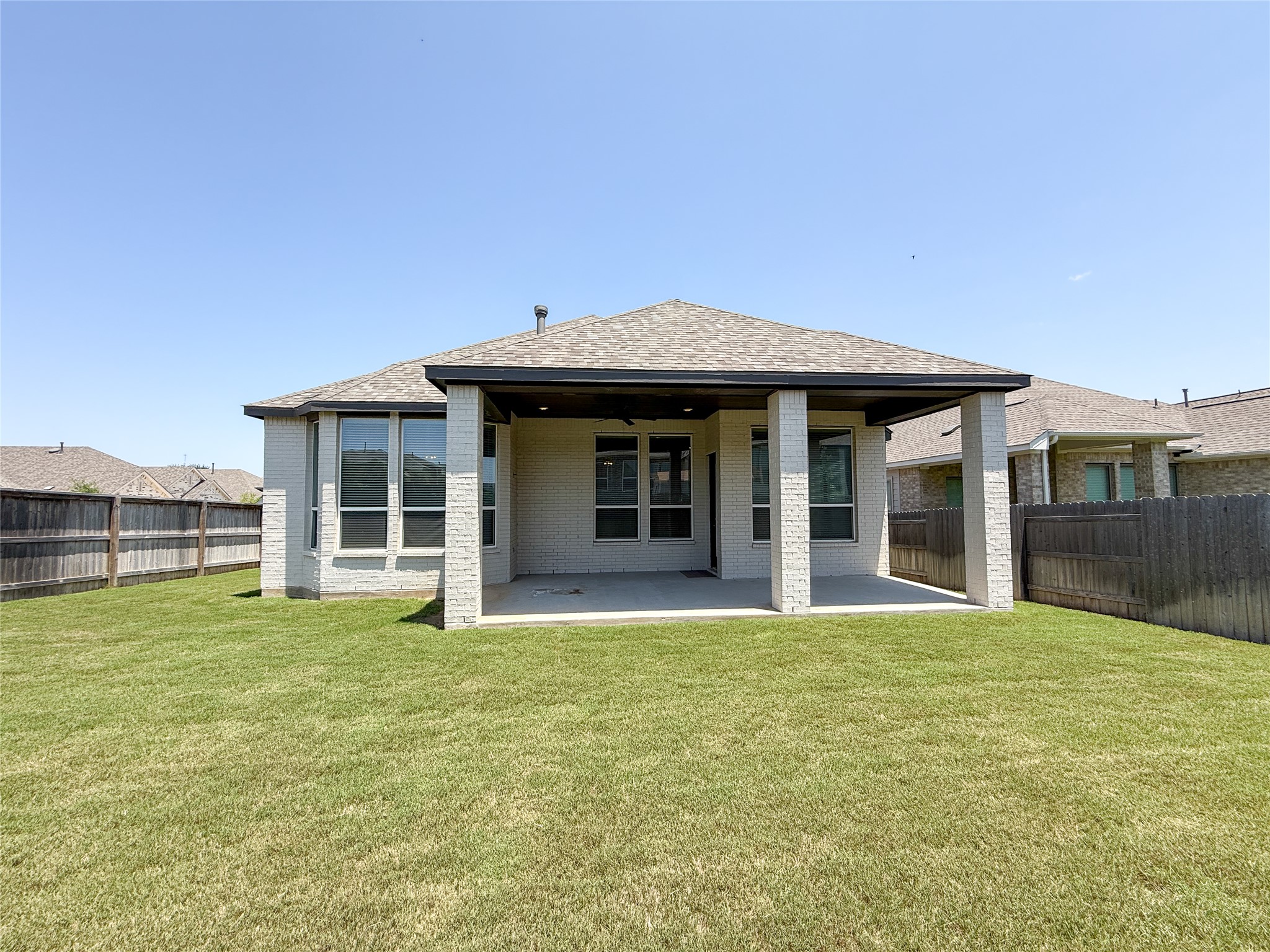 249 Heartleaf Road San Marcos, TX 78666 - Photo 34 of 38 A spacious backyard with an inviting covered patio, perfect for outdoor relaxation.