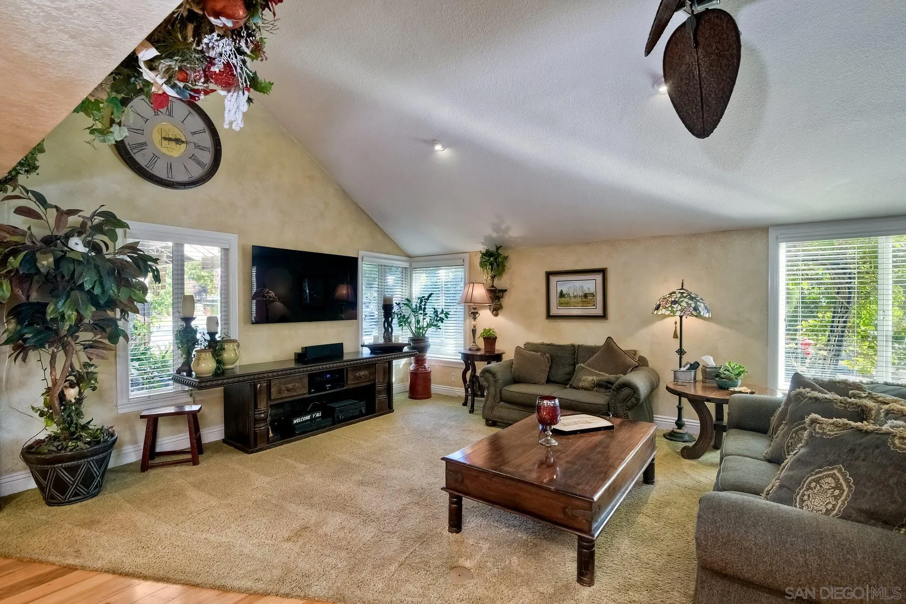 14248 Ipava Drive Poway, CA 92064 - Photo 7 of 34 a living room with furniture a flat screen tv and a large window