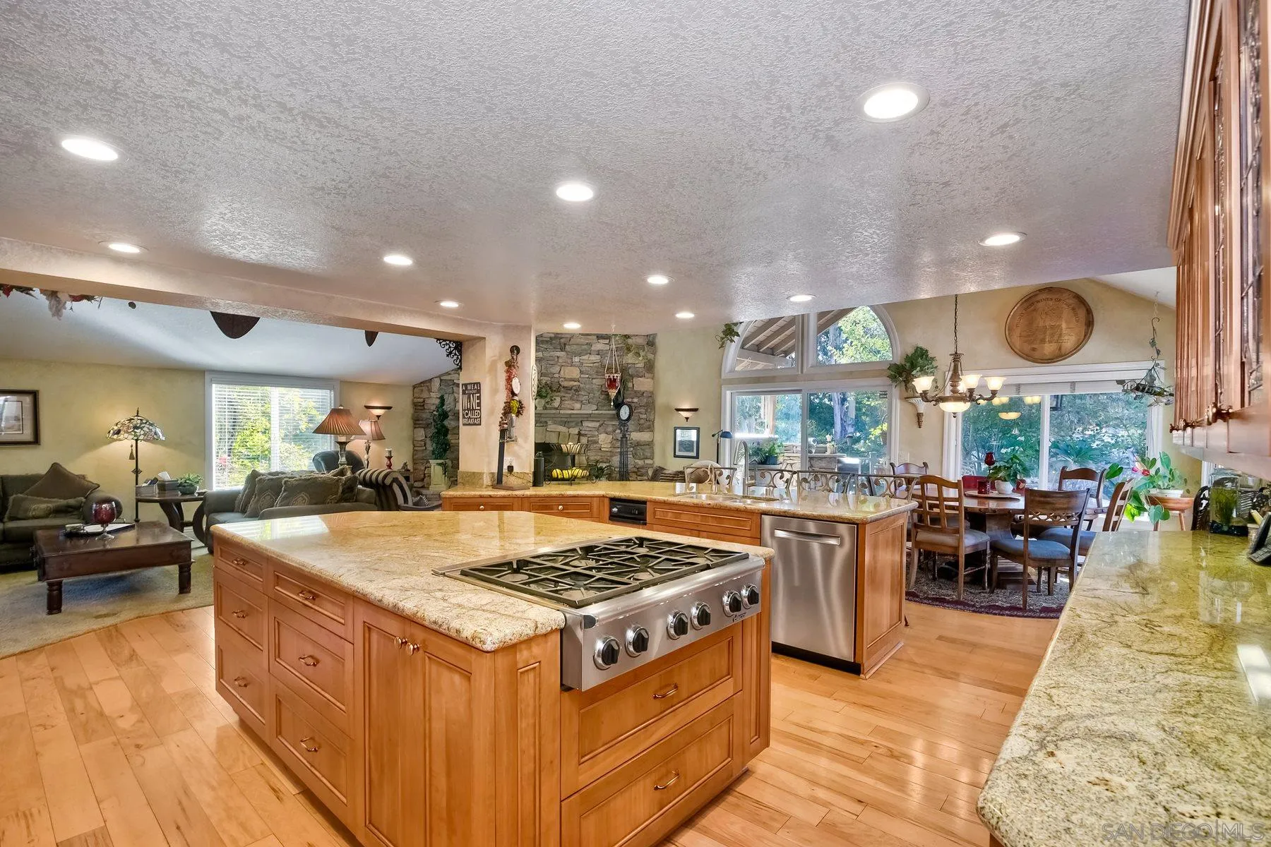14248 Ipava Drive Poway, CA 92064 - Photo 10 of 34 a kitchen with stainless steel appliances granite countertop a stove and a large countertops with wooden floor
