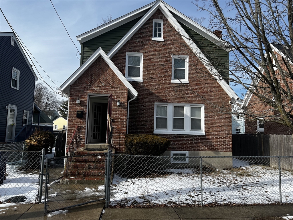 a front view of a house with sitting area