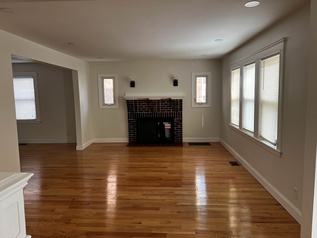 8 Winborough Street Boston, MA 02136 - Photo 2 of 12 a view of an empty room with window and fire place
