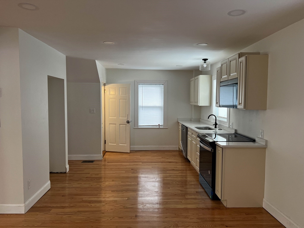 8 Winborough Street Boston, MA 02136 - Photo 4 of 12 a kitchen with stainless steel appliances a stove top oven a sink and a refrigerator