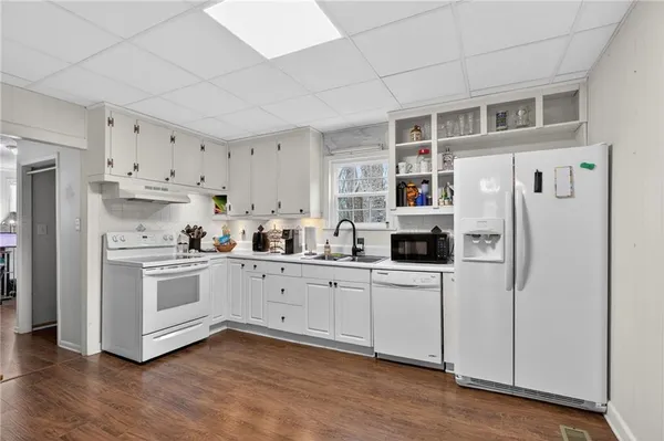 a kitchen with stainless steel appliances a refrigerator sink and cabinets
