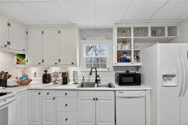 a kitchen with stainless steel appliances a refrigerator sink and cabinets
