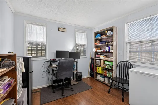 a view of a workspace with furniture and a window