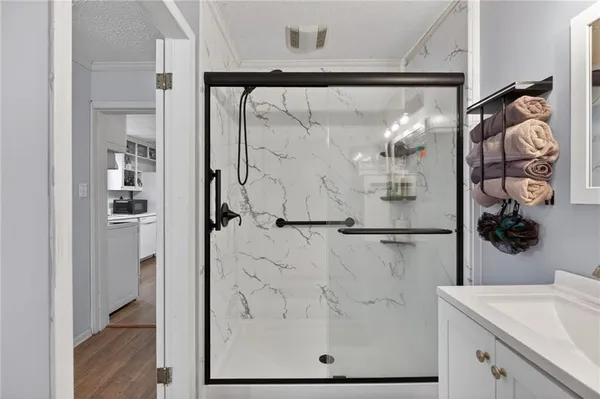 a bathroom with a shower and a sink