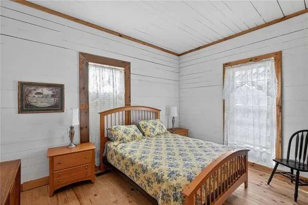 a bedroom with a bed and a table with lamp