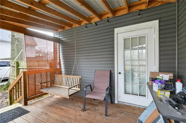 a backyard of a house with barbeque oven table and chairs