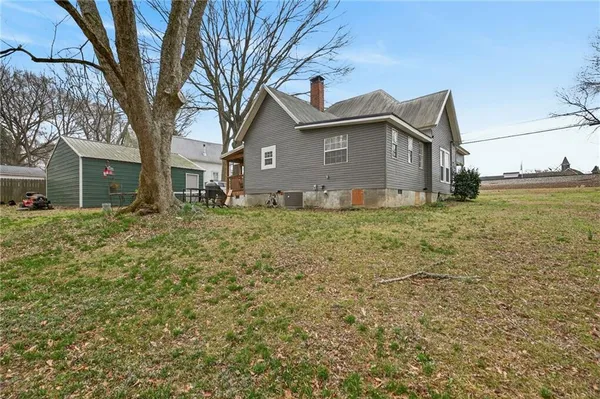 a view of a small house with a fence
