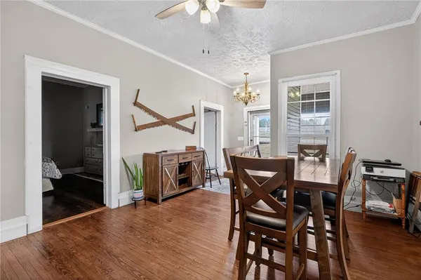a view of a dining room with furniture and wooden floor