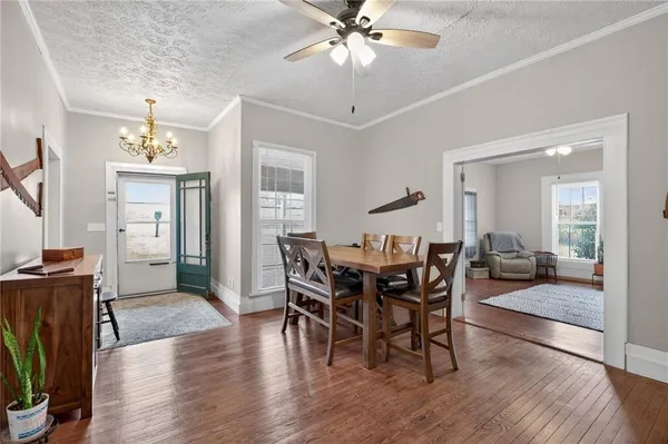 a view of a dining room with furniture and wooden floor