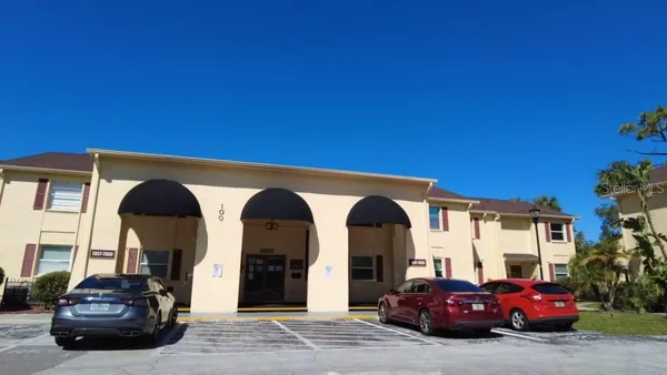 a couple of cars parked in front of a house