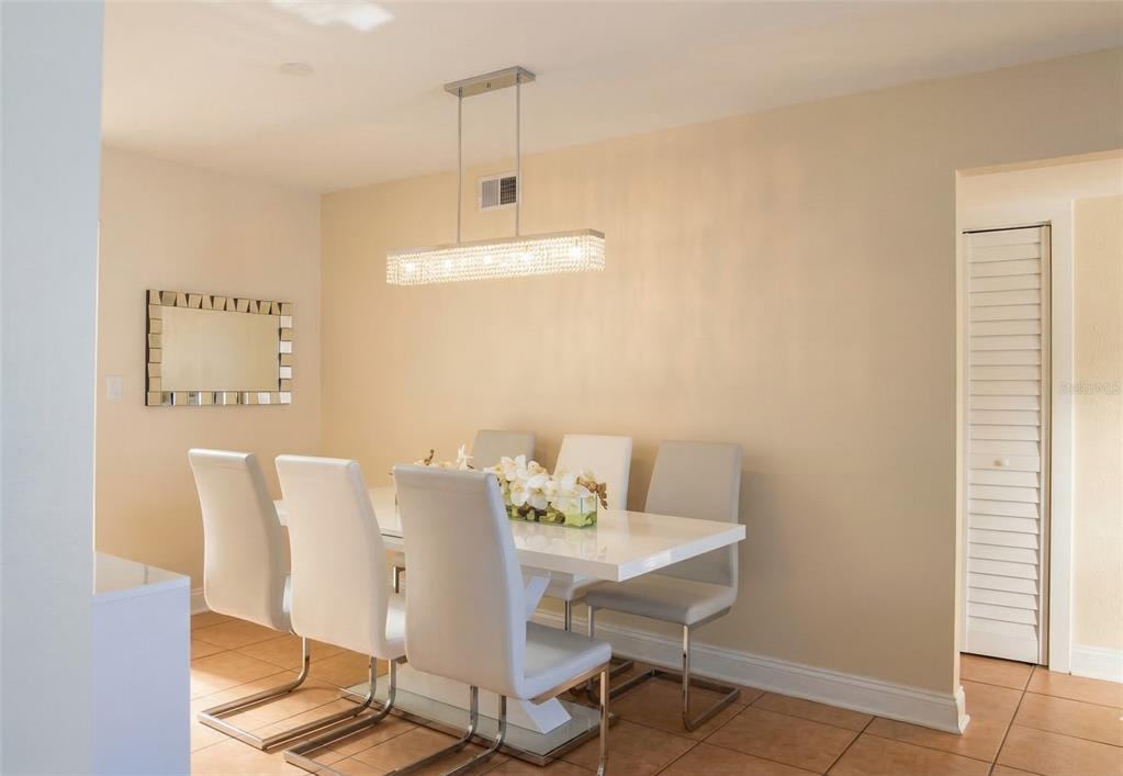 7327 Abonado Road, Unit 7327 Tampa, FL 33615 - Photo 2 of 9 a view of a dining room with furniture and chandelier