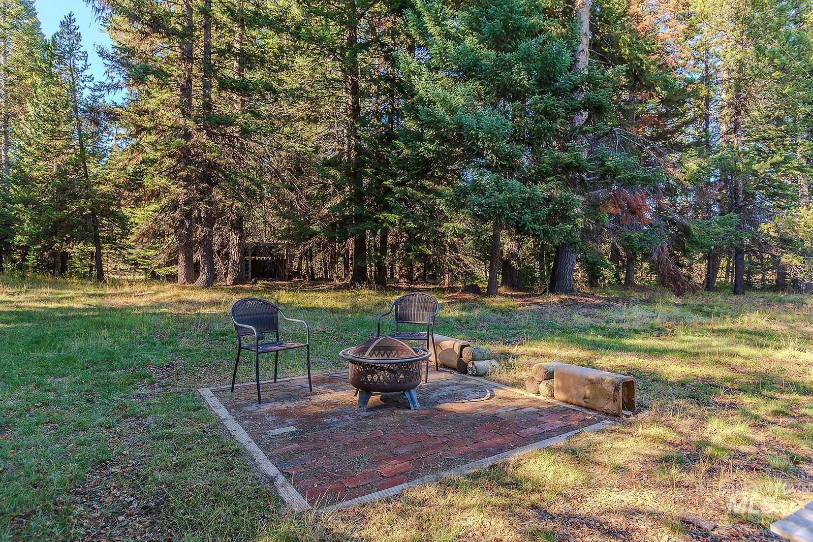 25314 Soldiers Meadow Road Winchester, ID 83555 - Photo 32 of 45 View of green lawn featuring a patio area and an outdoor fire pit