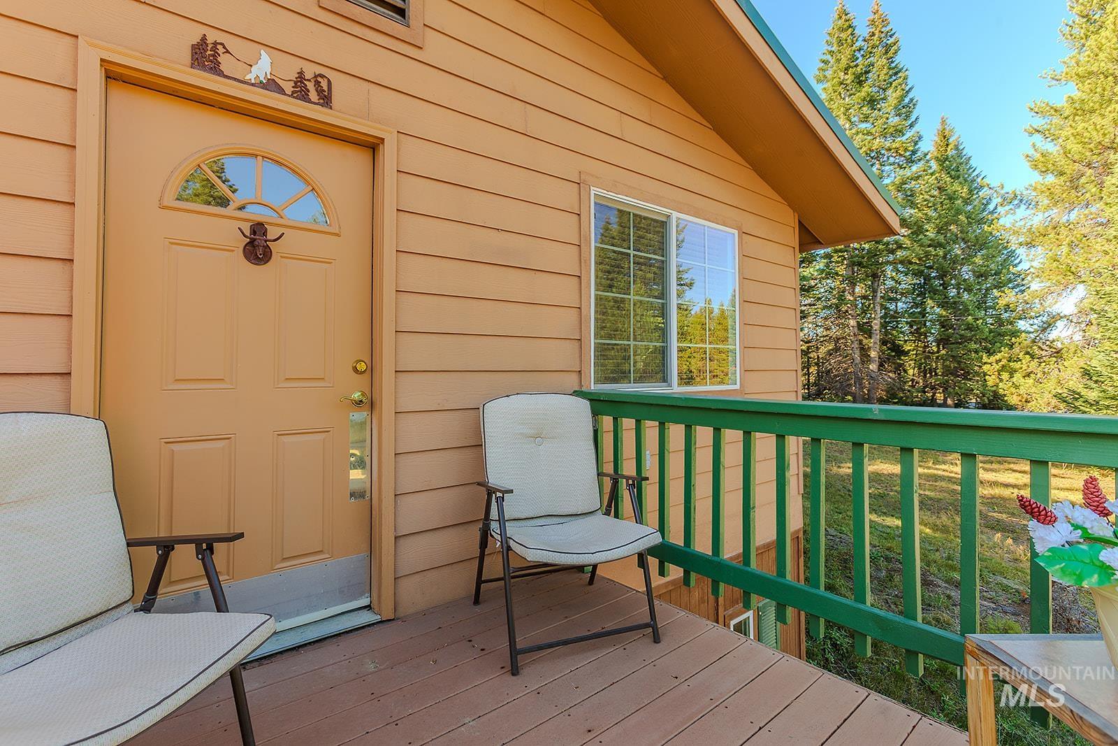 25314 Soldiers Meadow Road Winchester, ID 83555 - Photo 34 of 45 Wooden terrace featuring a lawn