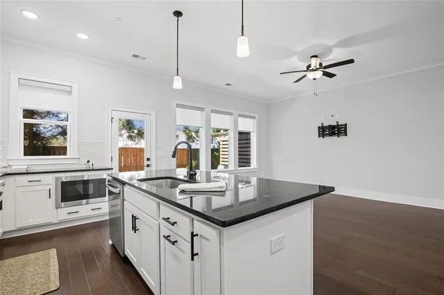 a bedroom with a bed and ceiling fan